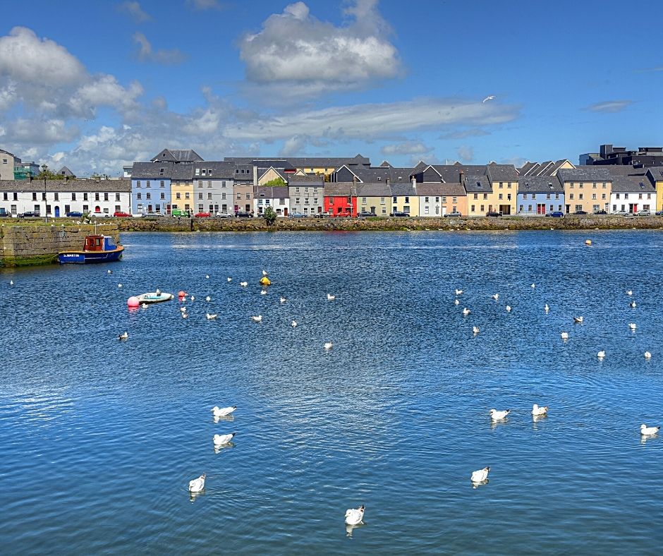 solo women travellers love the view from the Long Walk in Galway, Ireland, of the candy coloured houses