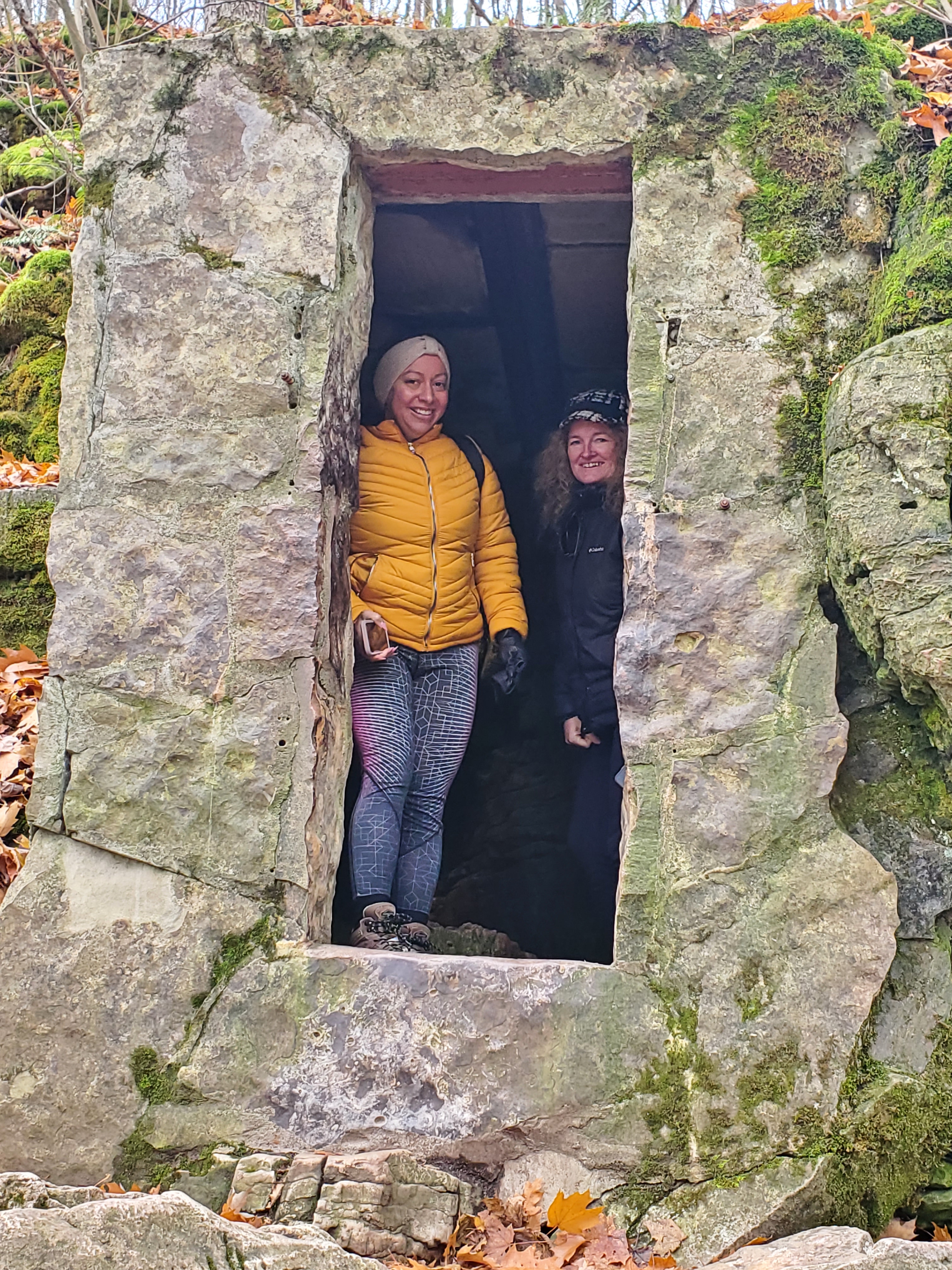 Exploring the first cave found near the base of the mountain before climbing many stairs to access the other caves and trails