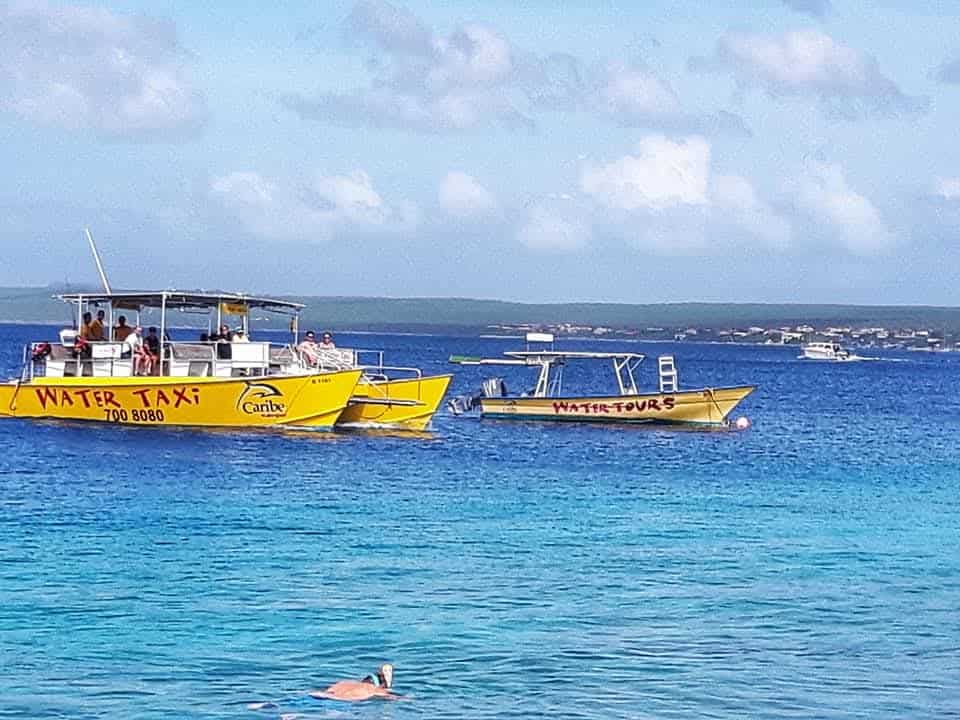 Water taxi and tour boat with tourists arriving at a resort on the Caribbean Island of Bonaire