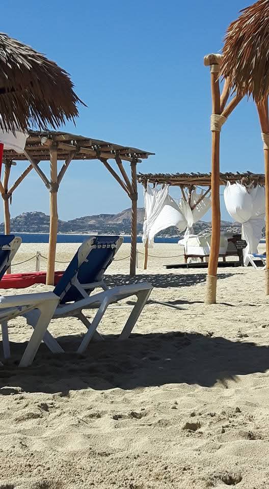 relaxing on the windy beach on a day bed when visiting Los Cabos