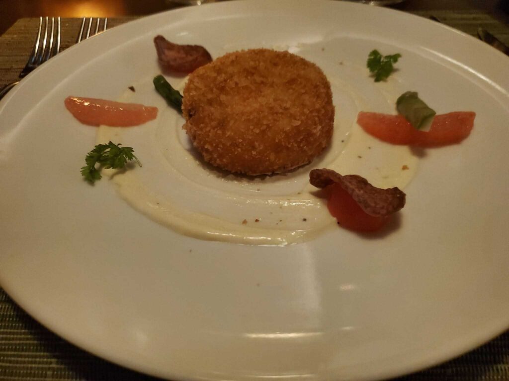 Fine dining with a crab cake on the Celebrity Beyond